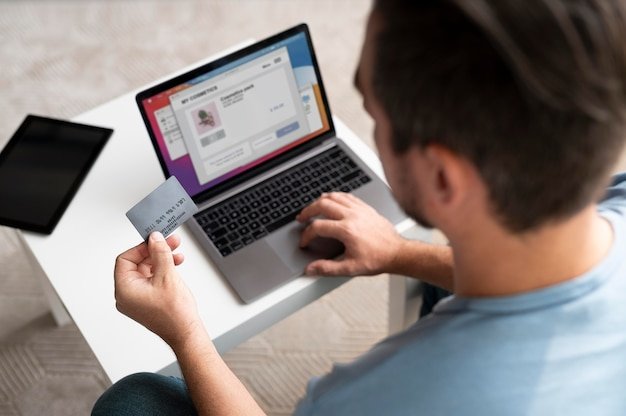 A person using a laptop to compare different credit card offers, with multiple browser tabs open showing various credit card websites and comparison charts.