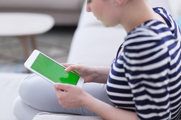 A person using the Robinhood mobile app on their phone. The app's interface is clean and minimalist, showing a stock chart and buy/sell buttons. The image conveys the app's ease of use and accessibility for mobile trading.