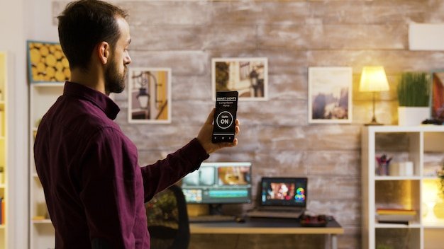 A user interacting with the Ring app on a smartphone, viewing live footage from a Ring security camera and controlling smart locks.