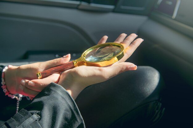 Close-up of a person's hand holding a magnifying glass over a buying guide, focusing on the fine print. This conveys the importance of scrutinizing the details and potential hidden biases within buying guides.