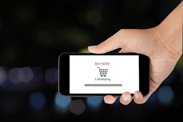 A close-up of a smartphone screen displaying a coupon code with a percentage discount, next to a shopping cart icon. The background is blurred to focus on the coupon details.