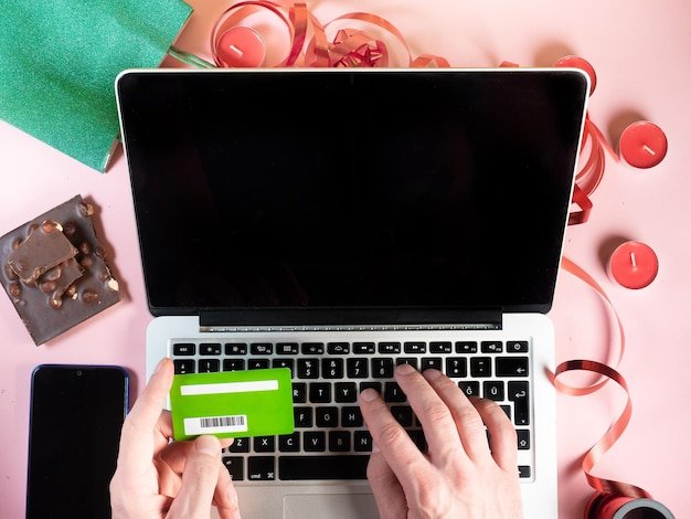 A laptop displaying a webpage with various coupon codes and a browser extension (like Honey) highlighting available discounts.