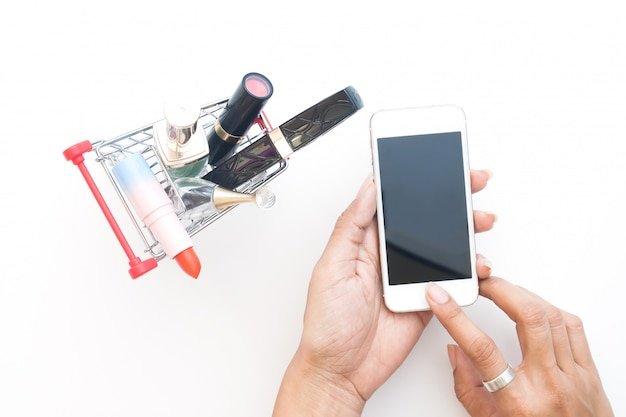 A person using a mobile app to scan a barcode on an electronic device, showcasing modern shopping tools.