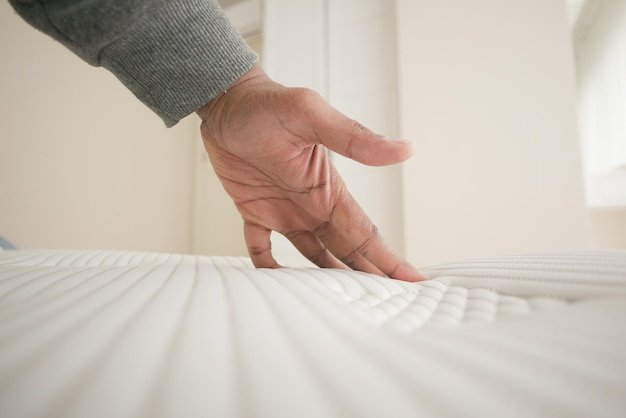A close-up showing the edge support of the Sleep Number i10, with a focus on the firmness and stability of the edge when pressure is applied.