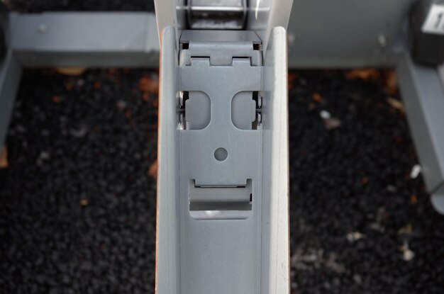 A close-up shot of the Yeti Tundra 45's hinge and latch system. The image highlights the robust construction and secure locking mechanism. The texture of the cooler's exterior is visible, emphasizing its ruggedness.