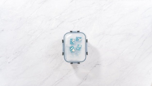 A bird's-eye view of the inside of a Yeti Tundra 45 cooler, packed with ice and various canned beverages and food items. The arrangement shows how the cooler can efficiently store a variety of goods, with ample ice distributed among them.