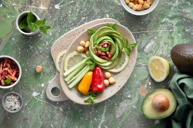 A vibrant photo showing a selection of vegetarian ingredients, including quinoa, bell peppers, avocados, and kale, arranged around a recipe card for a plant-based meal kit dish.