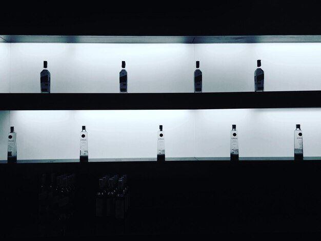 A split image: one side depicts a brightly lit showroom floor with prominently displayed prices, while the other shows a dimly lit back room with hidden costs and fine print.