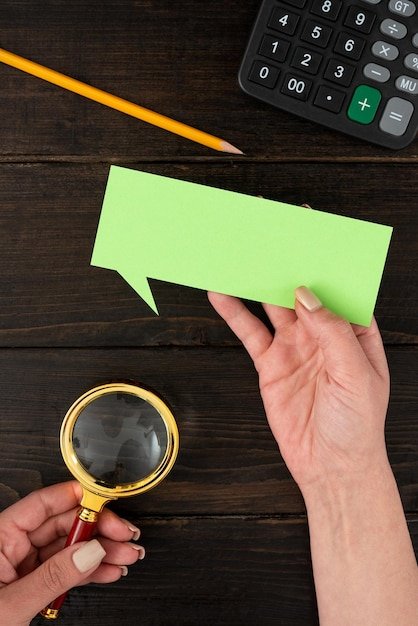 A person holding a magnifying glass over a buying guide, focusing on customer reviews, highlighting the importance of scrutinizing testimonials.