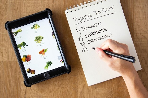 A person making a prioritized list with a pen and paper, highlighting important criteria for product selection.