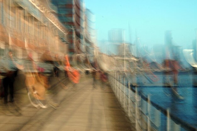 A split image showing cargo ships stuck in a harbor on one side and crowded shopping malls on the other, symbolizing the supply chain bottlenecks and increased consumer demand pushing prices up.