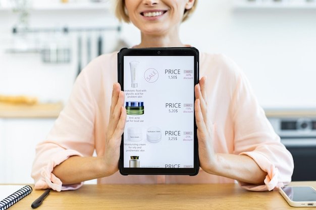 A person using a tablet to view a personalized buying guide, with relevant product recommendations and reviews displayed on the screen.