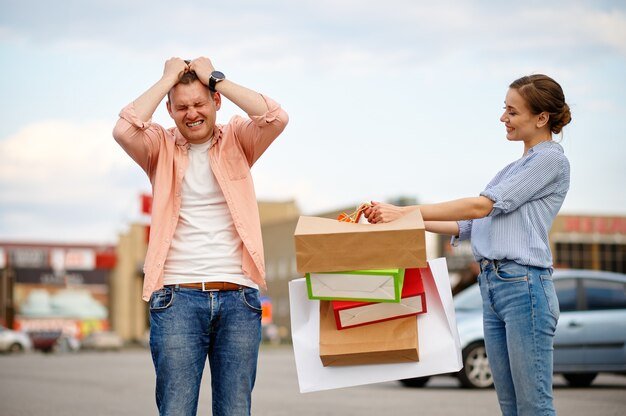 A person looking stressed and overwhelmed while comparing two similar products with vastly different price tags, symbolizing the dilemma of choosing between price and value.