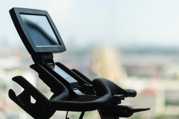 Close-up shot of the Peloton Bike+'s rotating screen, highlighting the clarity and responsiveness of the touchscreen interface. An instructor is visible on the screen leading a live class.