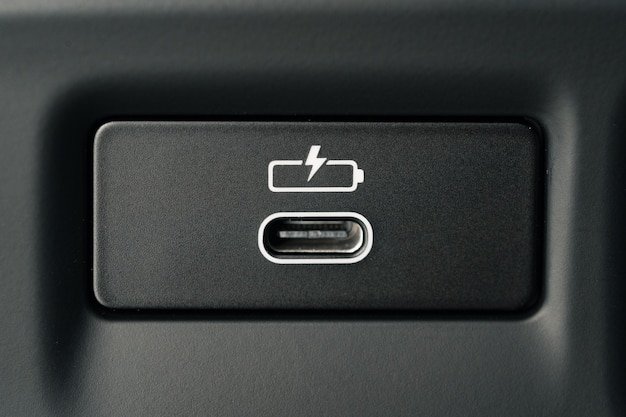 Close-up shot of the Ford F-150 Lightning 2025 charging port, showing the connector and charging status indicator illuminated.