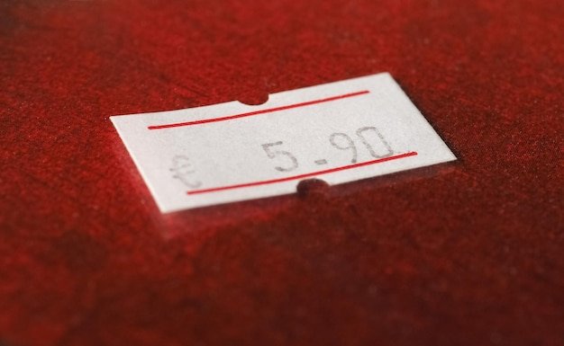 A close-up of a partially torn expired coupon, with the expiration date clearly visible. The background is blurred, focusing attention on the details of the coupon.