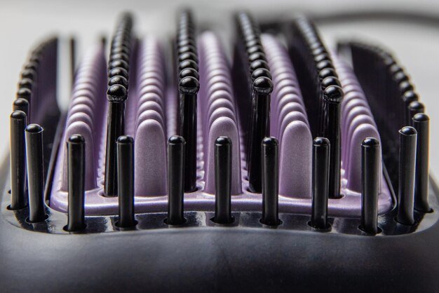 A detailed view of the Dyson Airwrap's Coanda effect in action, showing the air wrapping a strand of hair around the barrel.