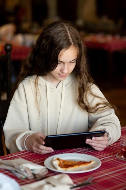 A user interacting with the Babbel app on a tablet, showcasing a lesson about ordering food at a restaurant in Spanish.