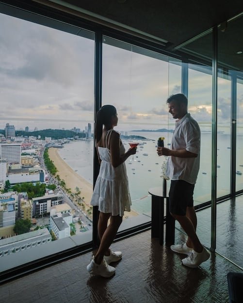 A luxurious hotel room showcasing a view of a cityscape or natural landscape. The setting implies a high-end travel experience, possibly funded by travel rewards earned from a credit card.