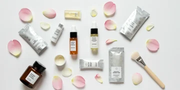Collection of free skincare samples on a white surface with flowers